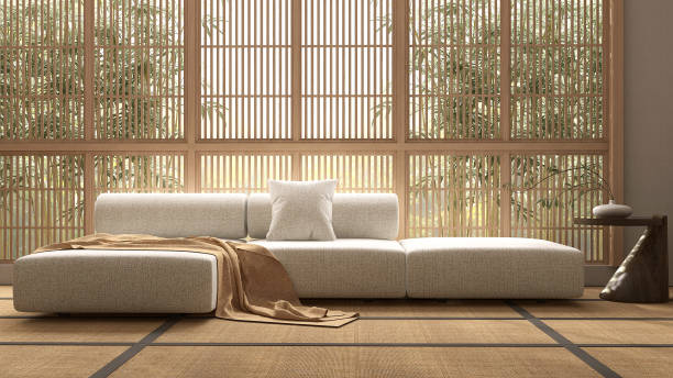 istock Modern, minimal white fabric bolster back corner sofa, cushion, wooden side table on Japanese traditional tatami mat floor in sunlight from wooden shoji window 1494734880