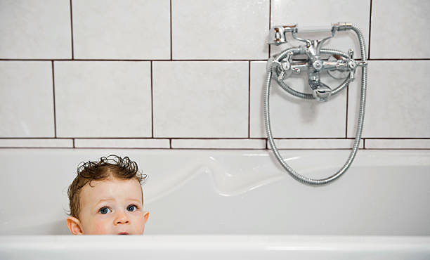 istock Baby look out from bathtub. 149473900