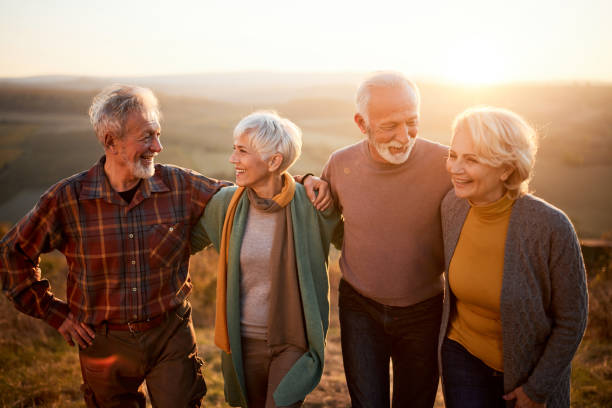 istock Happy mature couples talking while walking in autumn day. 1494739087