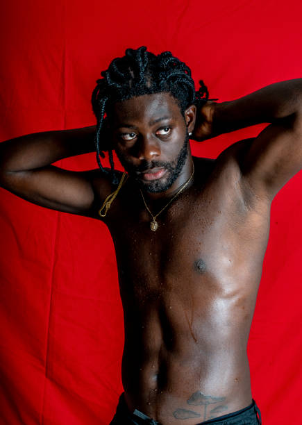 istock Shirtless young African man enjoys himself. 1494740997