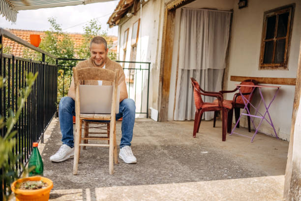 istock Man working on laptop in rural home 1494741089