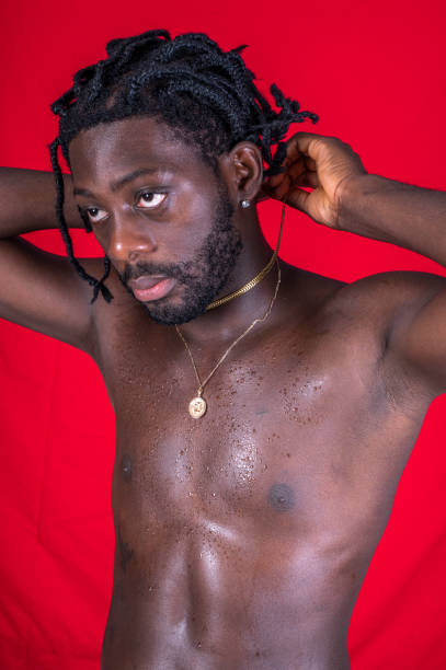 istock Shirtless young African man enjoys himself. 1494741109