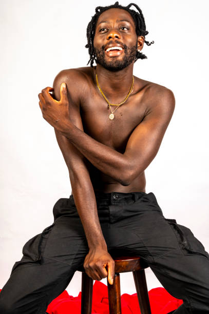 istock Shirtless young African man enjoys himself. 1494741175