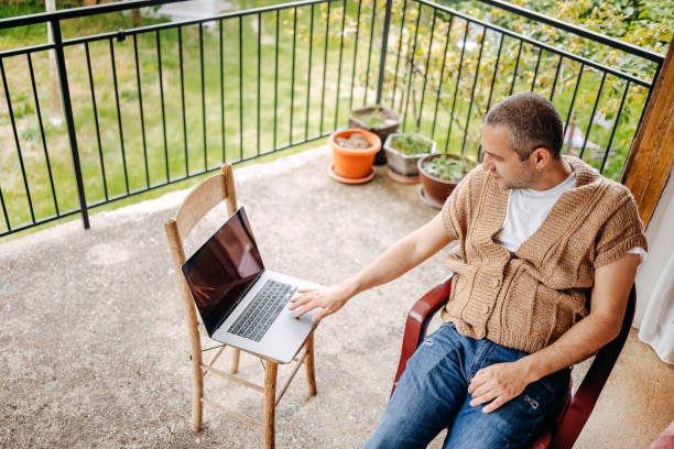 istock Man working on laptop in rural home 1494741260
