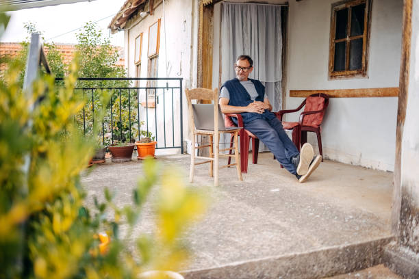 istock Man working on laptop in rural home 1494741307