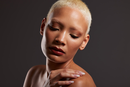 Beauty, makeup and face of black woman with eyes closed in dark studio with platinum hair isolated on grey background. Art aesthetic, cosmetics and beautiful African model with glowing skin facial.
