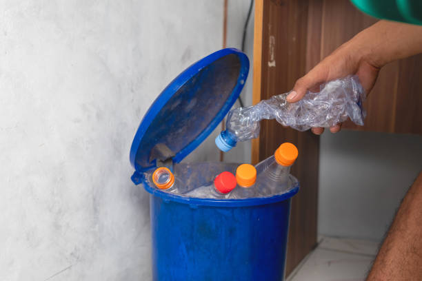 istock Male hand throwing trash empty plastic bottles into recycling bin 1494742657