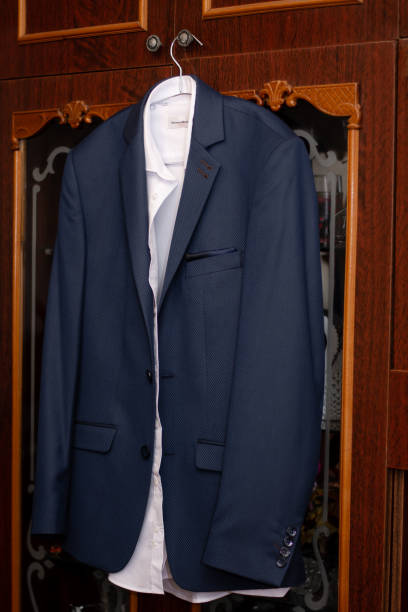 men's suit hanging on a hanger, at home.