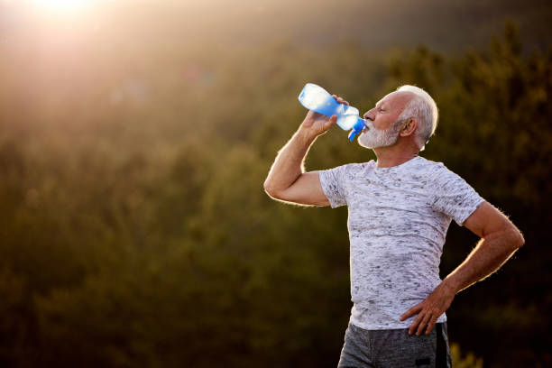 istock Senior male athlete having a water break in nature. 1494744771