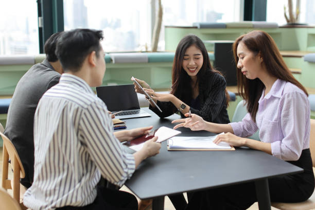istock Collaborative process of young asian business people team working together discussing, researching, brainstorming and planning work at business meeting in modern office building and city background 1494746467