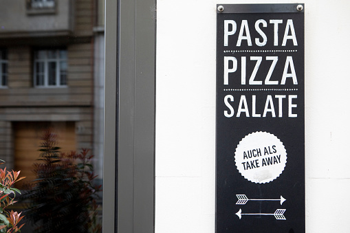 Pasta, pizza and salad sign outside a fat food restaurant in Basel, Switzerland