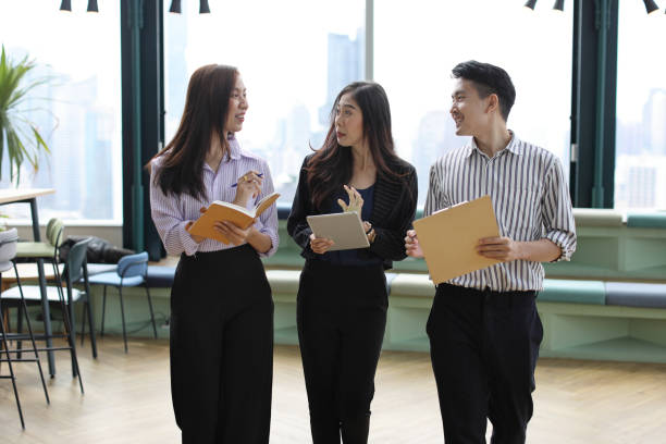 istock Collaborative process of young asian business people team working together discussing, researching, brainstorming and planning work at business meeting in modern office building and city background 1494746658