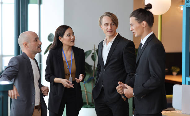 istock Collaborative process of multiethnic business people team working together discussing, researching, brainstorming and planning work at business meeting in modern office building and city background 1494746997