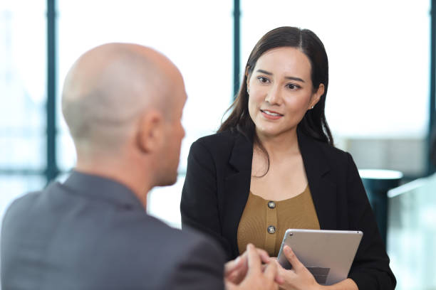 istock Collaborative process of multiethnic business people team working together discussing, researching, brainstorming and planning work at business meeting in modern office building and city background 1494747078