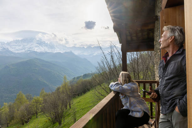 istock Mature couple enjoy view from mountain cabin 1494747195