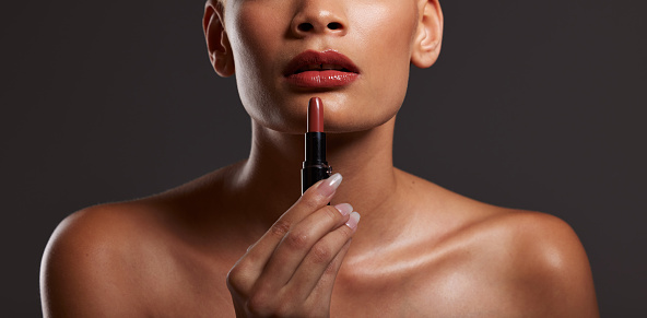 Beauty, makeup and lips of woman with lipstick in studio for cosmetics, skincare products and fashion. Salon aesthetic, cosmetology and girl model with red gloss for beauty, mouth and luxury style