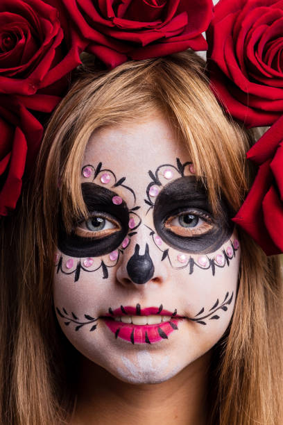 girl with painted face looking at camera in studio and ready to party
