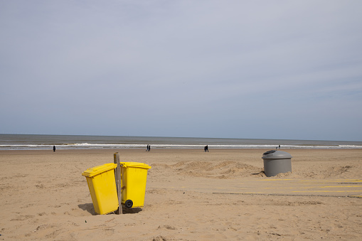 Dumpsters on a deserted sandy seashore