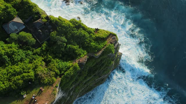 Aerial view of scenic coastline with cliffs and ocean with waves in Uluwatu, Bali