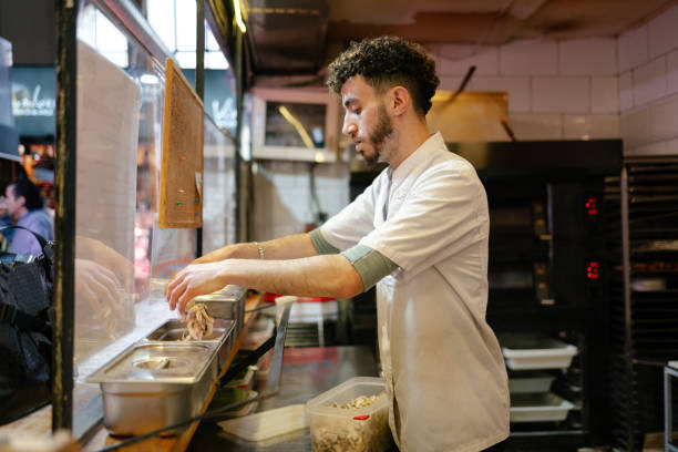 istock Pizza man putting ingredients in containers 1494749158