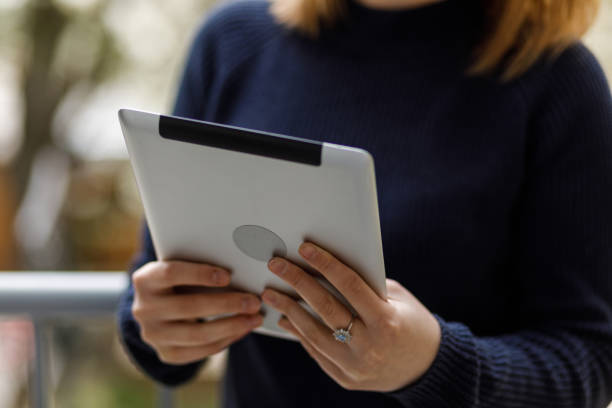 istock Young woman enjoying some fresh air on the balcony and using digital tablet 1494749597