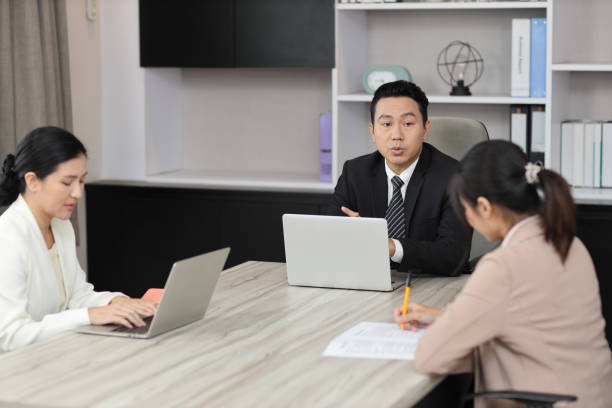 istock Collaborative process of young asian business people team working together discussing, researching, brainstorming and planning work at business meeting in modern office building and city background 1494750199