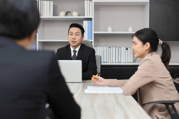 istock Collaborative process of young asian business people team working together discussing, researching, brainstorming and planning work at business meeting in modern office building and city background 1494750220