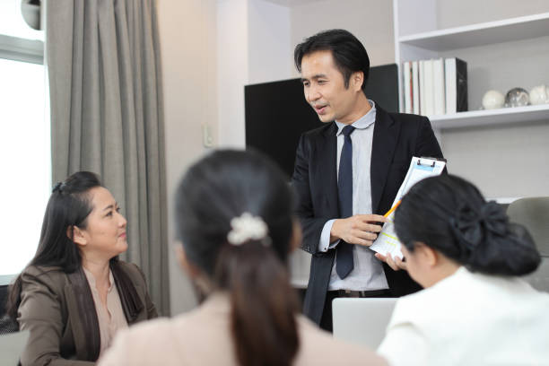 istock Collaborative process of young asian business people team working together discussing, researching, brainstorming and planning work at business meeting in modern office building and city background 1494750489