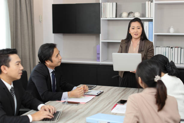 istock Collaborative process of professional businesspeople going over on new project together, using computer presentation and brainstorming ideas, coworker and working together at office meeting concept 1494750507