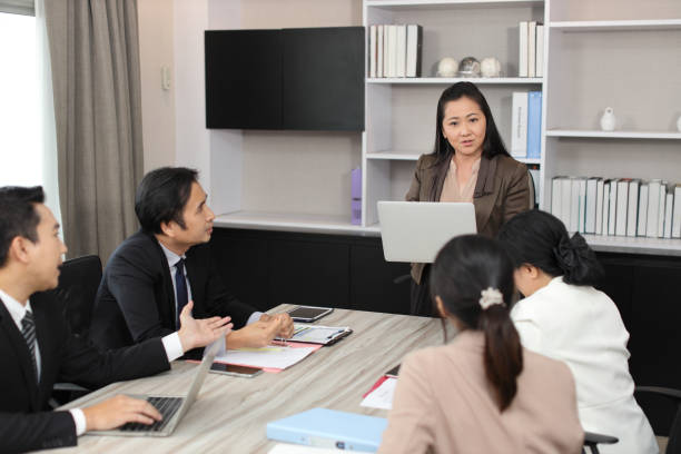 istock Collaborative process of professional businesspeople going over on new project together, using computer presentation and brainstorming ideas, coworker and working together at office meeting concept 1494750515