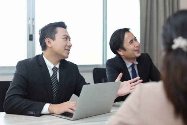 istock Collaborative process of young asian business people team working together discussing, researching, brainstorming and planning work at business meeting in modern office building and city background 1494750528