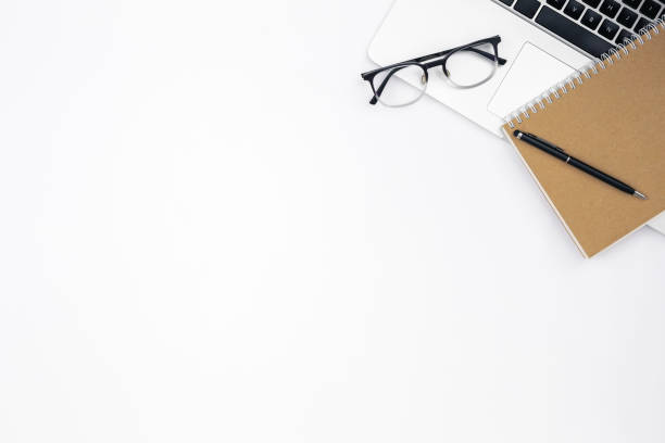 istock Laptop, notebook and glasses on a white background, top view. 1494753151