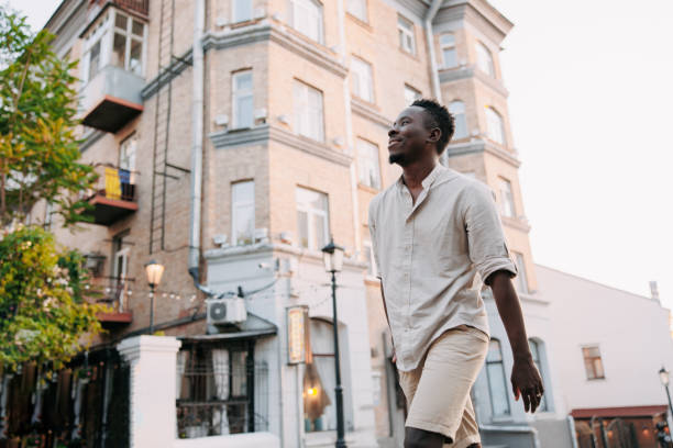 istock Young smiling african man is walking on street. 1494753520