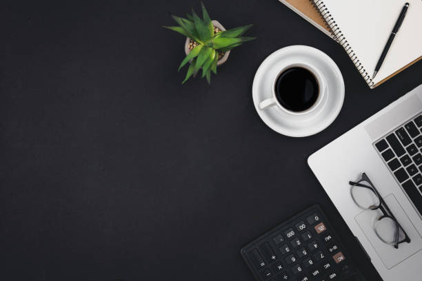 istock Laptop, coffee cups and notepads on a black background, top view. 1494753650