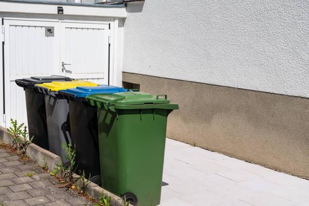 istock Multi-colored plastic bins for separate waste collection near the garage. 1494754355