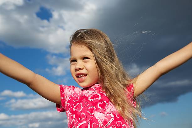 istock Excited Young Girl against Cloudy Sky 149475463