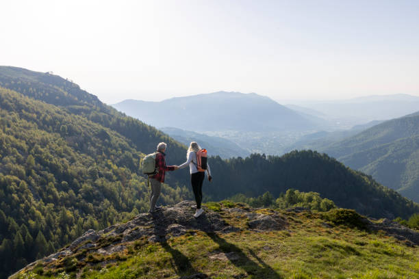 istock Mature couple explore mountain meadow in morning light 1494754663