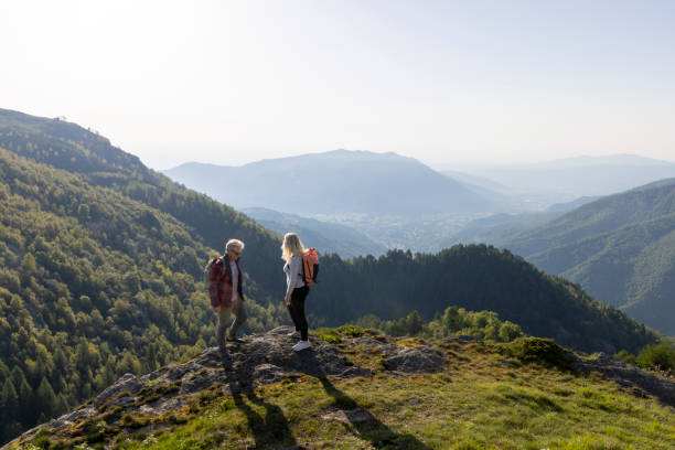 istock Mature couple explore mountain meadow in morning light 1494754759