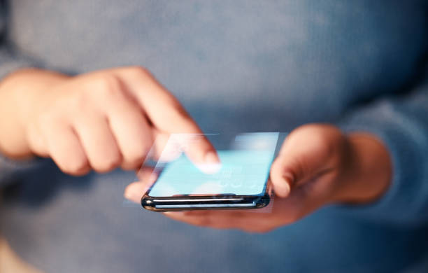 istock Hands typing, phone screen and hologram in office, data or holographic financial statistics. Futuristic, graphs or business woman with mobile smartphone for networking, web browsing or 3d digital app 1494757215