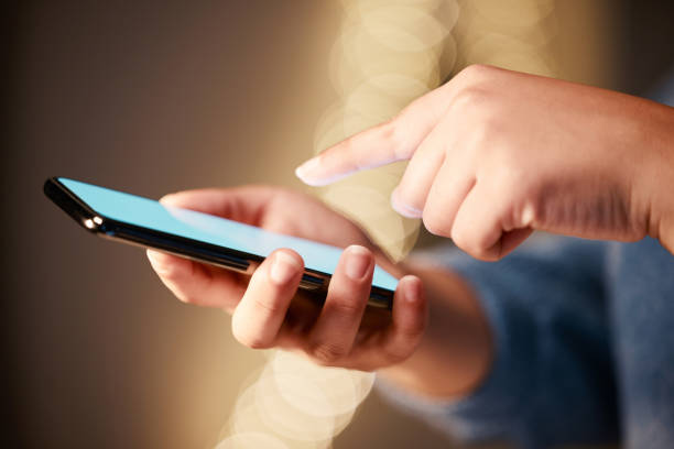 istock Hands, phone screen and typing in night office, texting or social media in workplace. Mockup, greenscreen and business woman with mobile smartphone for networking, web scrolling or internet browsing 1494757216