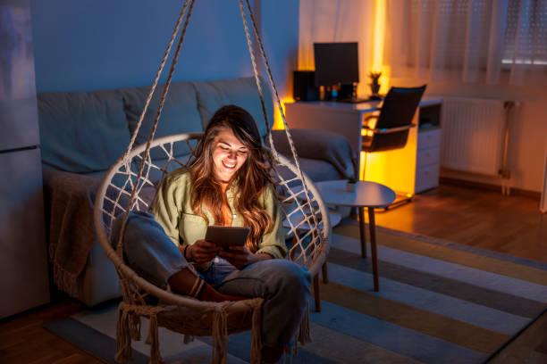 istock Woman reading an ebook at home 1494759286