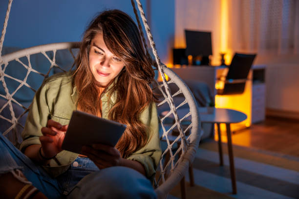 istock Woman relaxing at home reading an e-book 1494759293