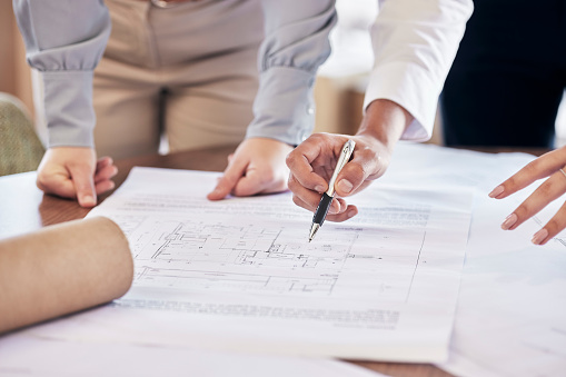 Team work, hands or architect drawing a blueprint or planning a real estate building or development in an office. Civil engineering, zoom or designers with vision of renovation or project management