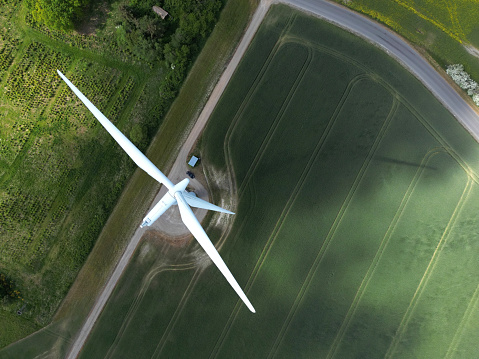 Aerial view of a power generating windturbine on a sunny day in  Denmark