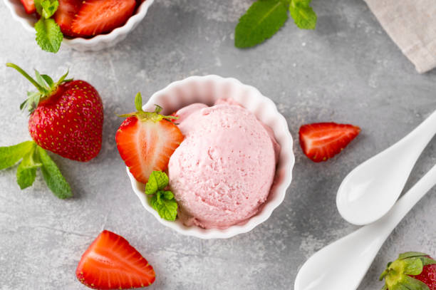 istock Strawberry ice cream with fresh berries in a bowl on a gray concrete background. Selective focus 1494761811