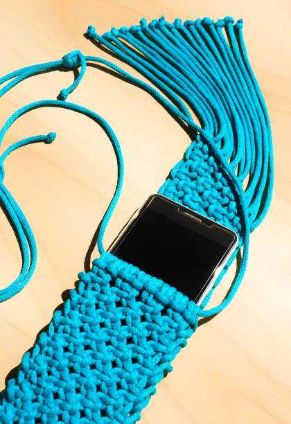 istock Bag knitted with macrame technique for a mobile phone. 1494764914