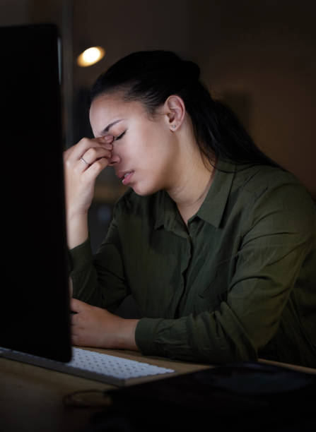 istock Computer, headache and stress by woman in office suffering from burnout, depressed and overworked. Dark, evening and corporate professional person frustrated, overtime and sick or sad employee 1494768344