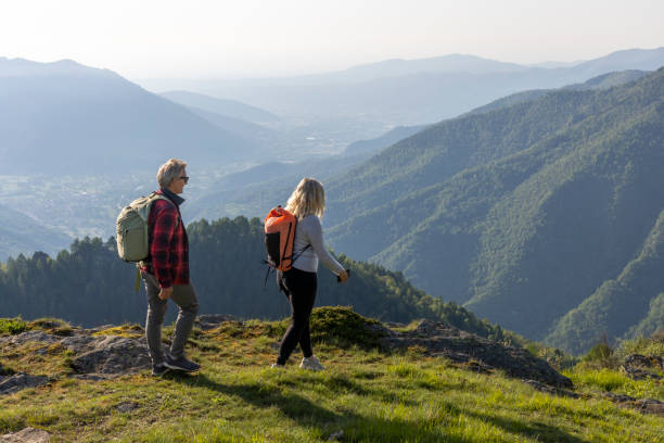 istock Mature couple explore mountain meadow in morning light 1494768949