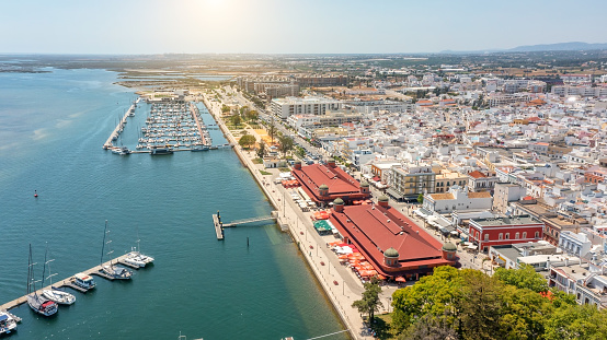 Aerial view of Portuguese fishing tourist town of Olhao with a view the Ria Formosa Marine Park. Sea port for yachts. High quality photo