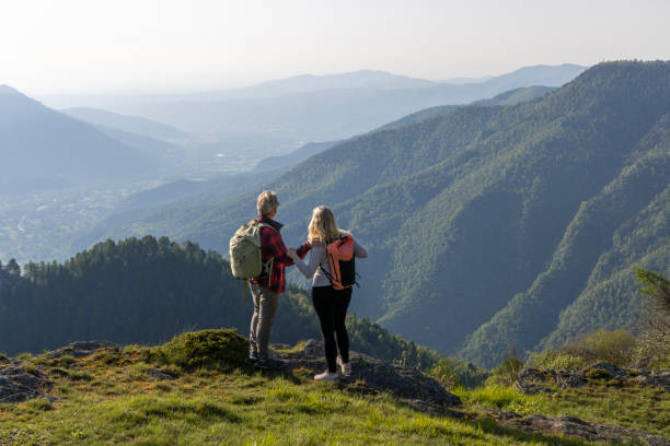 istock Mature couple explore mountain meadow in morning light 1494770059